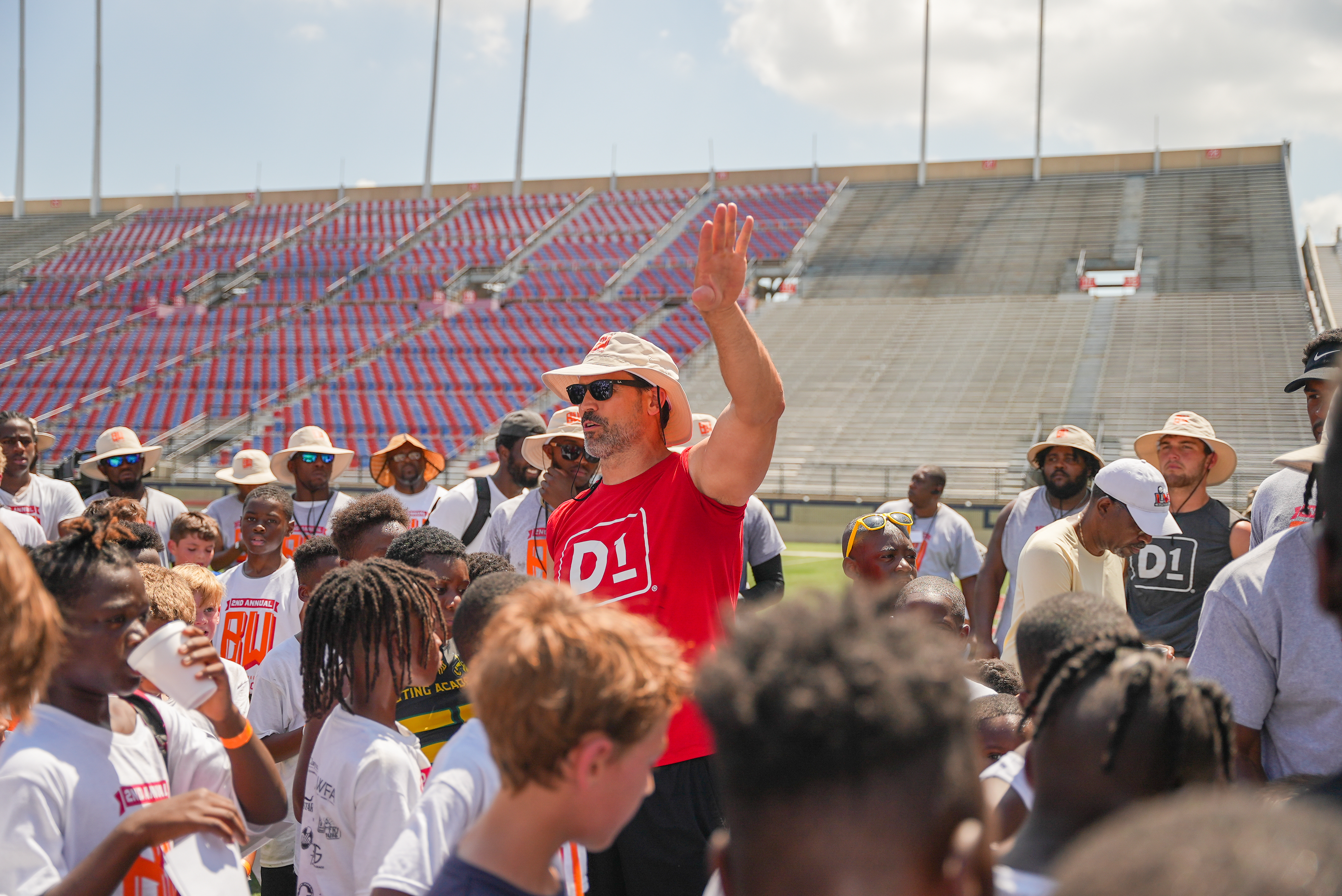 Coach addressing a youth football camp in the stadium