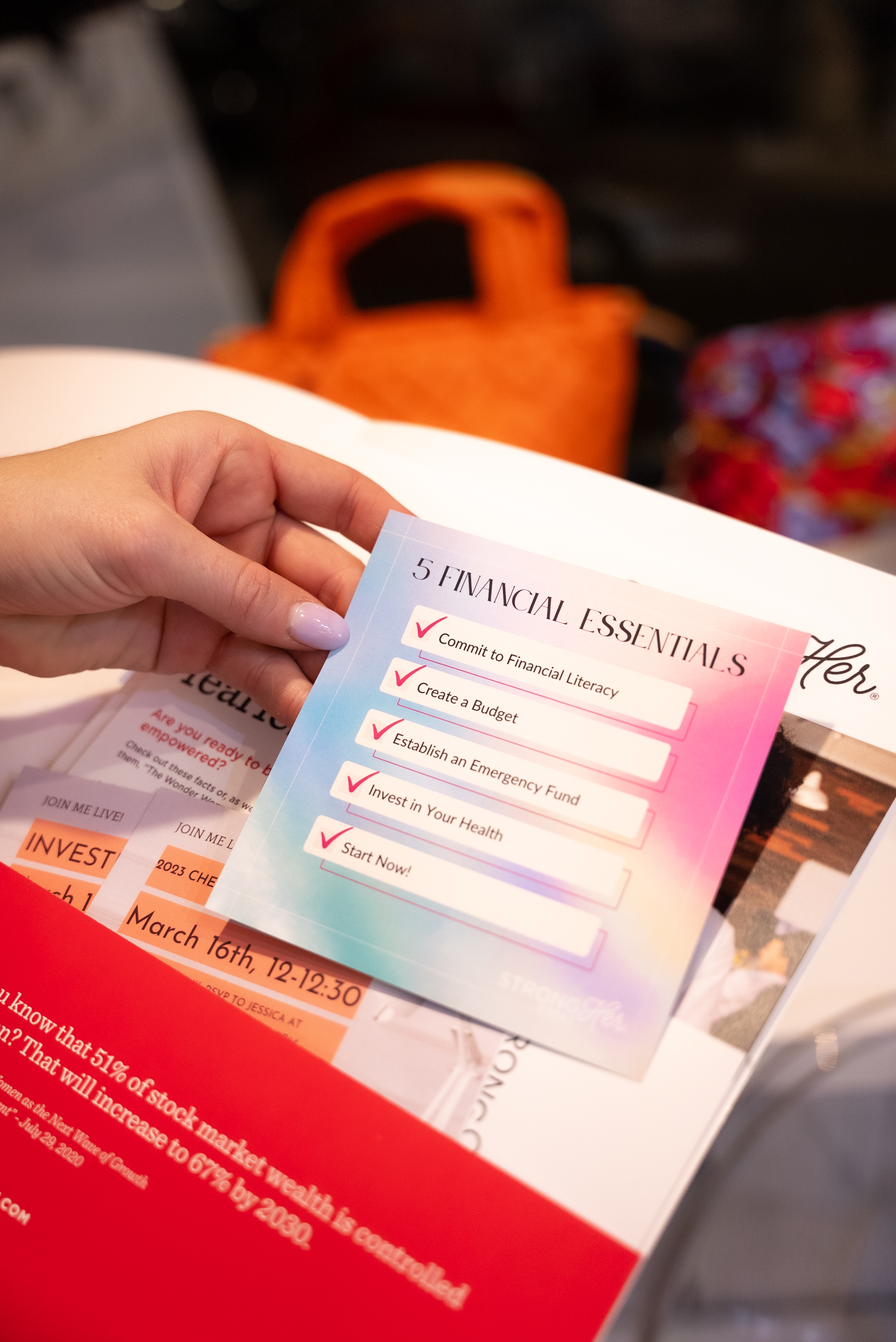 StrongHer Money® 5 Financial Essentials card at an event
